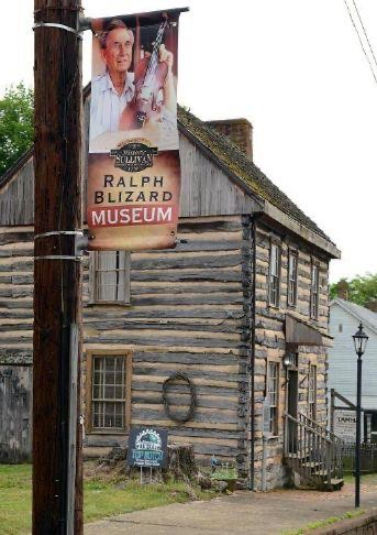 The Ralph Blizard Museum in the log Anderson Townhouse in Blountville, Tennessee, with a banner of Blizard holding his fiddle