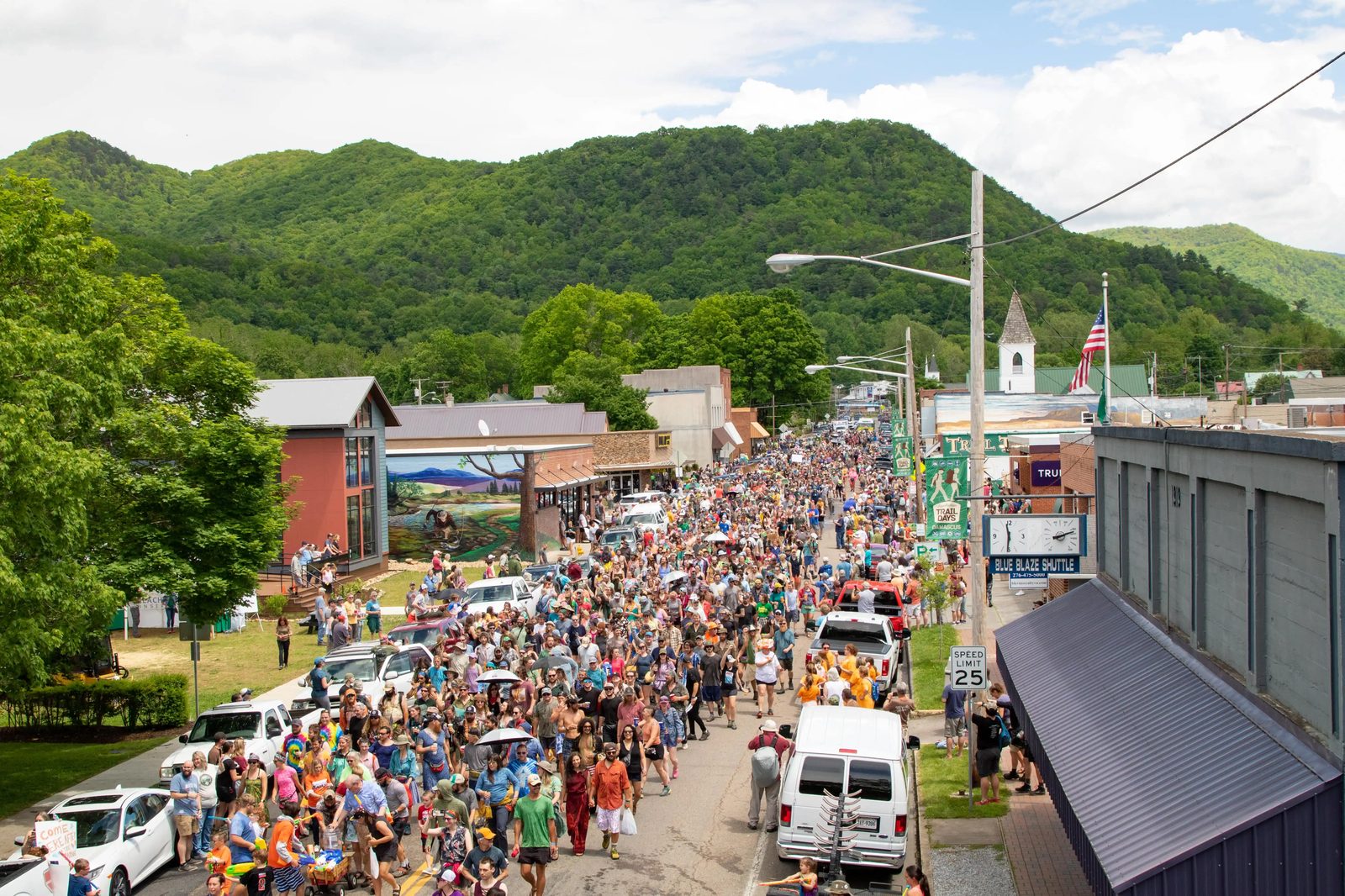 A packed downtown street lined with mountains during a festival in Damascus, Virginia